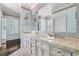 Elegant bathroom with a double vanity, marble countertop, and classic sconce lighting at 401 Peachtree Battle Nw Ave, Atlanta, GA 30305