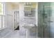 Bright bathroom featuring marble floors, walls, pedestal sink, and glass shower at 401 Peachtree Battle Nw Ave, Atlanta, GA 30305