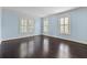 Spacious bedroom with three windows and dark wood floors at 401 Peachtree Battle Nw Ave, Atlanta, GA 30305