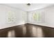 Light-filled bedroom with hardwood floors, white walls, and windows with shutters at 401 Peachtree Battle Nw Ave, Atlanta, GA 30305