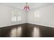 Bright and airy bedroom with dark hardwood floors and two large windows with classic white shutters at 401 Peachtree Battle Nw Ave, Atlanta, GA 30305