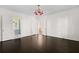 Bright bedroom with dark hardwood floors, white walls, and an attached bathroom at 401 Peachtree Battle Nw Ave, Atlanta, GA 30305