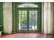 Elegant bonus room with brick floors and french doors that lead to the outdoor pool area at 401 Peachtree Battle Nw Ave, Atlanta, GA 30305