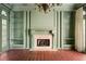 View of the bonus room, featuring a fireplace, custom built-ins, and brick flooring at 401 Peachtree Battle Nw Ave, Atlanta, GA 30305