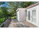 Wooden deck with black metal railing offering outdoor seating and relaxing views of lush greenery at 401 Peachtree Battle Nw Ave, Atlanta, GA 30305