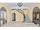 Spacious foyer with elegant staircase, arched doorways, and refined decorative accents at 401 Peachtree Battle Nw Ave, Atlanta, GA 30305