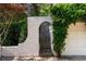 Charming archway and wooden staircase leading to the upper level, nestled next to the garage at 401 Peachtree Battle Nw Ave, Atlanta, GA 30305
