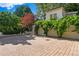 Three-car garage with climbing vines set in brick driveway offers ample parking and curb appeal at 401 Peachtree Battle Nw Ave, Atlanta, GA 30305