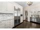 Kitchen with stainless appliances and marble backsplash and countertops, and dark wood floors at 401 Peachtree Battle Nw Ave, Atlanta, GA 30305