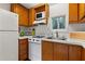 Well-lit kitchen with wood cabinets and white appliances, offering functionality and charm at 401 Peachtree Battle Nw Ave, Atlanta, GA 30305