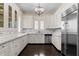 Bright, well-equipped kitchen with marble counters, stainless steel appliances, and dark wood floors at 401 Peachtree Battle Nw Ave, Atlanta, GA 30305