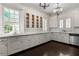 Kitchen with marble counters, stainless appliances, wood floors, and window overlooking the yard at 401 Peachtree Battle Nw Ave, Atlanta, GA 30305