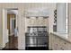 Gourmet kitchen with Viking range and marble countertops with wine storage and wood floors at 401 Peachtree Battle Nw Ave, Atlanta, GA 30305