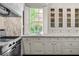 Well-appointed kitchen with white cabinetry, marble countertops, and stainless steel appliances at 401 Peachtree Battle Nw Ave, Atlanta, GA 30305