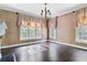 Room with hardwood floors, traditional wallpaper, a large window, and decorative chandelier at 401 Peachtree Battle Nw Ave, Atlanta, GA 30305