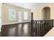 Large living room with dark hardwood floors and natural light from multiple windows at 401 Peachtree Battle Nw Ave, Atlanta, GA 30305