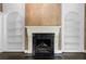 Living room with fireplace flanked by built in bookshelves and dark wood floors at 401 Peachtree Battle Nw Ave, Atlanta, GA 30305
