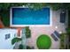 Aerial view of luxurious backyard pool and patio area with green space, lounge chairs and privacy at 401 Peachtree Battle Nw Ave, Atlanta, GA 30305