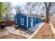 View of the blue exterior of the house, with a deck and stone landscaping in the backyard at 674 Atlanta Se Ave, Atlanta, GA 30312