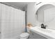 Cozy bathroom with marble-patterned tile, a round mirror, and shower with curtain at 674 Atlanta Se Ave, Atlanta, GA 30312