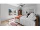 Sunlit bedroom with a ceiling fan, wood floors, and open windows at 674 Atlanta Se Ave, Atlanta, GA 30312