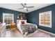 Serene bedroom with blue walls, wooden floors, and an artful arrangement of wall decor at 674 Atlanta Se Ave, Atlanta, GA 30312