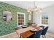 Dining room boasts vibrant wallpaper, wooden table, and modern chandelier at 674 Atlanta Se Ave, Atlanta, GA 30312