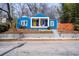 Charming blue bungalow with a cozy front porch, bright yellow door, and landscaped front yard at 674 Atlanta Se Ave, Atlanta, GA 30312
