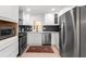 Modern kitchen with white cabinetry, stainless steel appliances, and stylish backsplash at 674 Atlanta Se Ave, Atlanta, GA 30312