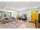 Bright, open living room with hardwood floors, modern decor, and a colorful yellow door at 674 Atlanta Se Ave, Atlanta, GA 30312