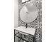 Stylish powder room features patterned tile wall and a modern round mirror at 674 Atlanta Se Ave, Atlanta, GA 30312