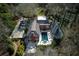 Breathtaking aerial view of an estate featuring a pool, lush landscaping, and a charming brick house at 0 Winterthur, Sandy Springs, GA 30328