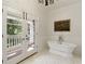 Bright bathroom with a clawfoot tub, french doors to a balcony, and a view of the exterior at 0 Winterthur, Sandy Springs, GA 30328