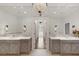 Bright bathroom with a chandelier, dual sinks, and full mirrors at 0 Winterthur, Sandy Springs, GA 30328