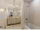 Elegant bathroom featuring a tub, shower, vintage mirror, and sconce lighting at 0 Winterthur, Sandy Springs, GA 30328