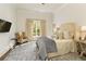 Bright bedroom with patterned rug, upholstered chair, and serene outdoor view at 0 Winterthur, Sandy Springs, GA 30328