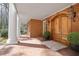 Inviting brick porch with wooden double doors, columns, and lantern-style lighting at 0 Winterthur, Sandy Springs, GA 30328