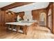 Kitchen with custom wood cabinets, a large island with dog beds, and hardwood floors at 0 Winterthur, Sandy Springs, GA 30328