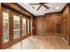 Wood-paneled office with built-in shelves and french doors leading to an outdoor patio at 0 Winterthur, Sandy Springs, GA 30328
