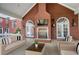 Charming covered patio with a brick fireplace, comfortable seating, and elegant decor, ideal for year-round enjoyment at 0 Winterthur, Sandy Springs, GA 30328