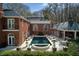 Beautiful pool area with manicured landscaping and ample space for lounging, set against a backdrop of mature trees at 0 Winterthur, Sandy Springs, GA 30328