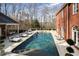 Inviting in-ground pool with an expansive patio, surrounded by lush greenery and comfortable lounge seating at 0 Winterthur, Sandy Springs, GA 30328
