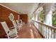 Long brick porch with rocking chairs, large columns, and view of the outdoors at 0 Winterthur, Sandy Springs, GA 30328