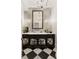 Elegant powder room with black and white tile flooring, ornate vanity, and decorative mirror at 0 Winterthur, Sandy Springs, GA 30328