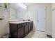 Well-lit bathroom featuring a dark vanity, large mirror, and tiled floors at 120 Centennial Ridge Dr, Acworth, GA 30102