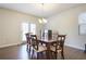 Dining room with a chandelier, hardwood floors, and a dining table with chairs near a sliding glass door at 120 Centennial Ridge Dr, Acworth, GA 30102
