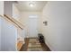 Bright foyer with hardwood floors, a staircase, a bench, and a white front door at 120 Centennial Ridge Dr, Acworth, GA 30102