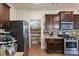 Kitchen with stainless steel appliances, granite countertops, dark cabinets, and walk-in pantry at 120 Centennial Ridge Dr, Acworth, GA 30102