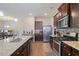Modern kitchen featuring granite countertops, stainless steel appliances, and dark wood cabinetry at 120 Centennial Ridge Dr, Acworth, GA 30102