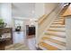 Open floor plan with hardwood floors, staircase, and a view into the living area and kitchen at 120 Centennial Ridge Dr, Acworth, GA 30102